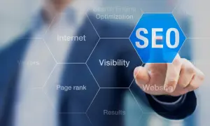 Palec wskazuje na niebieski sześciokąt z napisem SEO. Wokół widoczne są hasła: Internet, Search Engine Optimization, Keywords, Visibility, Website, Results, Page rank, Visitors. To podpowiedź, jak zbadac element.